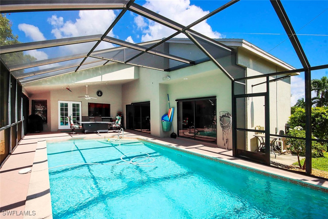 a view of a backyard with table and chairs under an umbrella