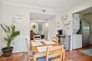 a dining room with furniture and wooden floor