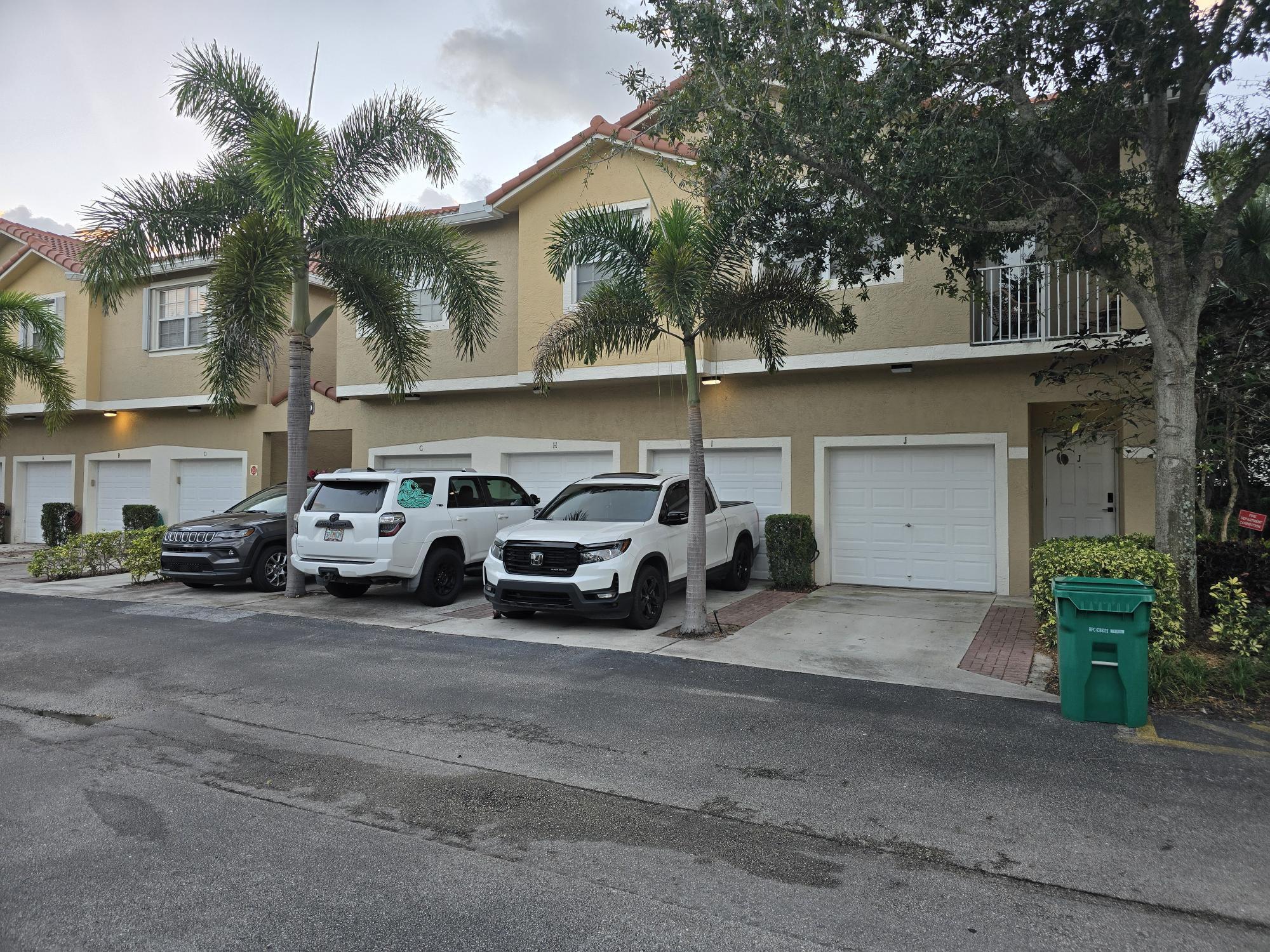 a couple of cars parked in front of a house