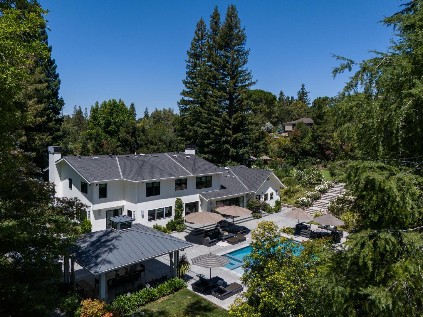 an aerial view of a house with yard and outdoor seating