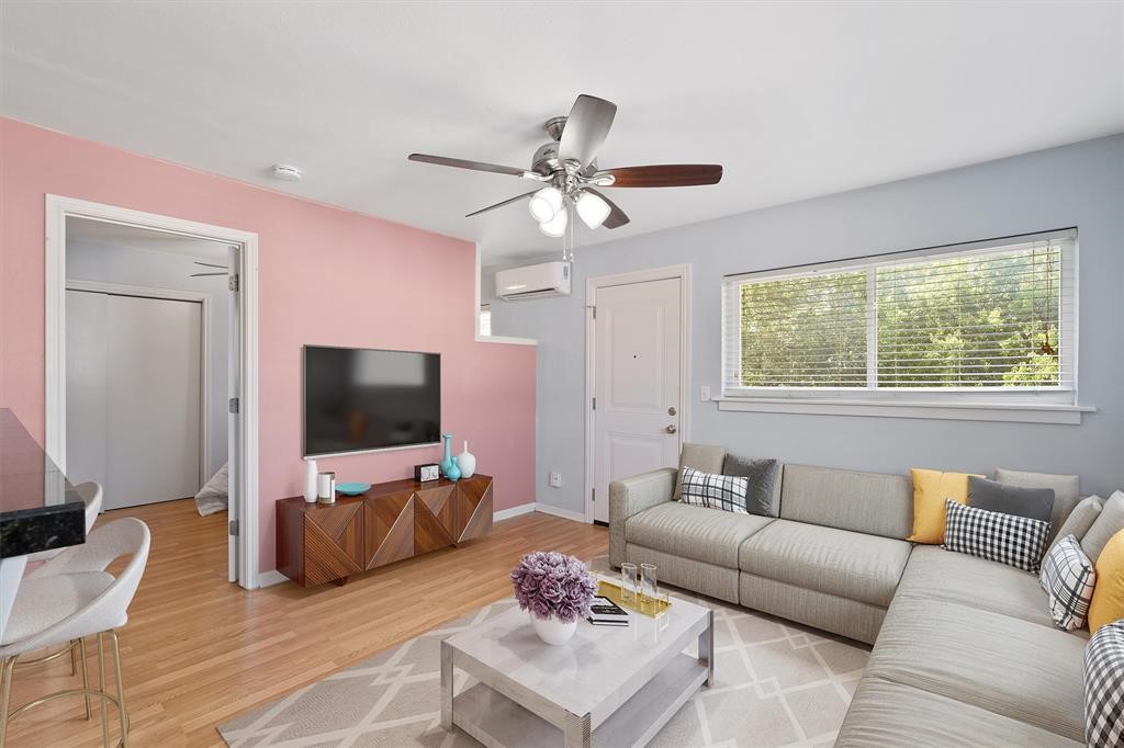 a living room with furniture and a flat screen tv