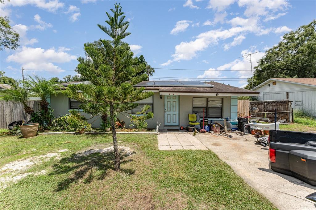 a view of a house with backyard porch and sitting area