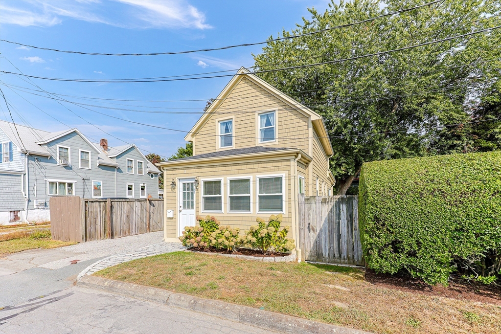 a view of a house with a yard and plants