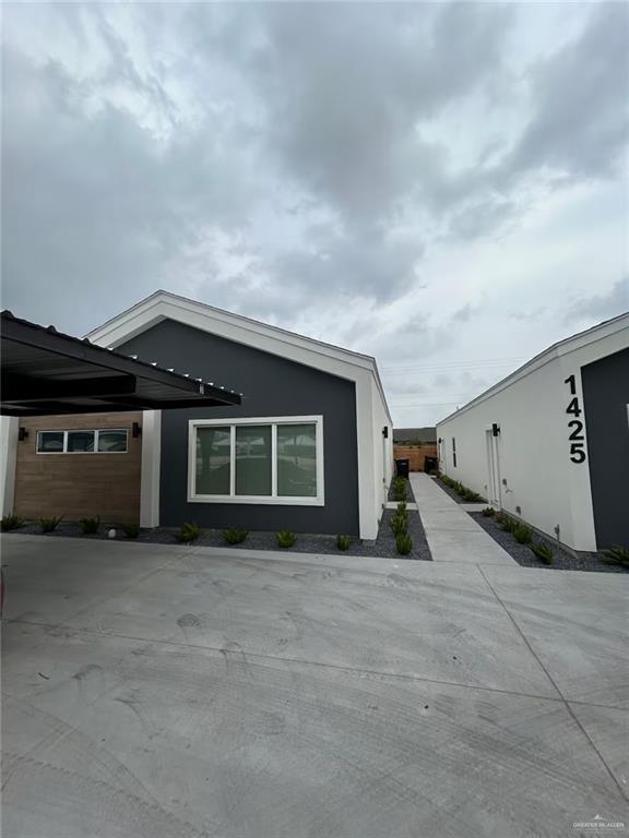 View of property exterior featuring a carport