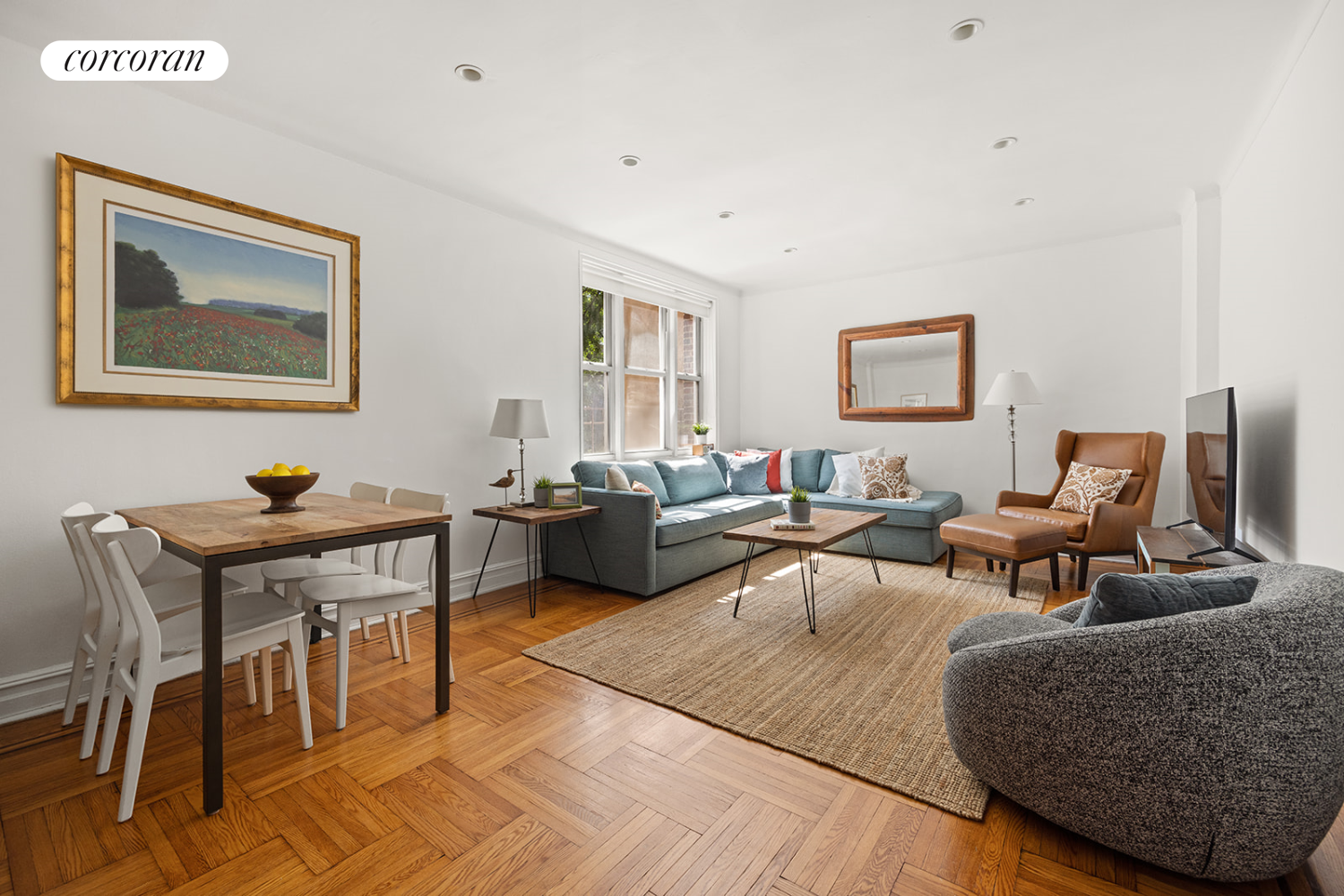 a living room with furniture a rug and a window