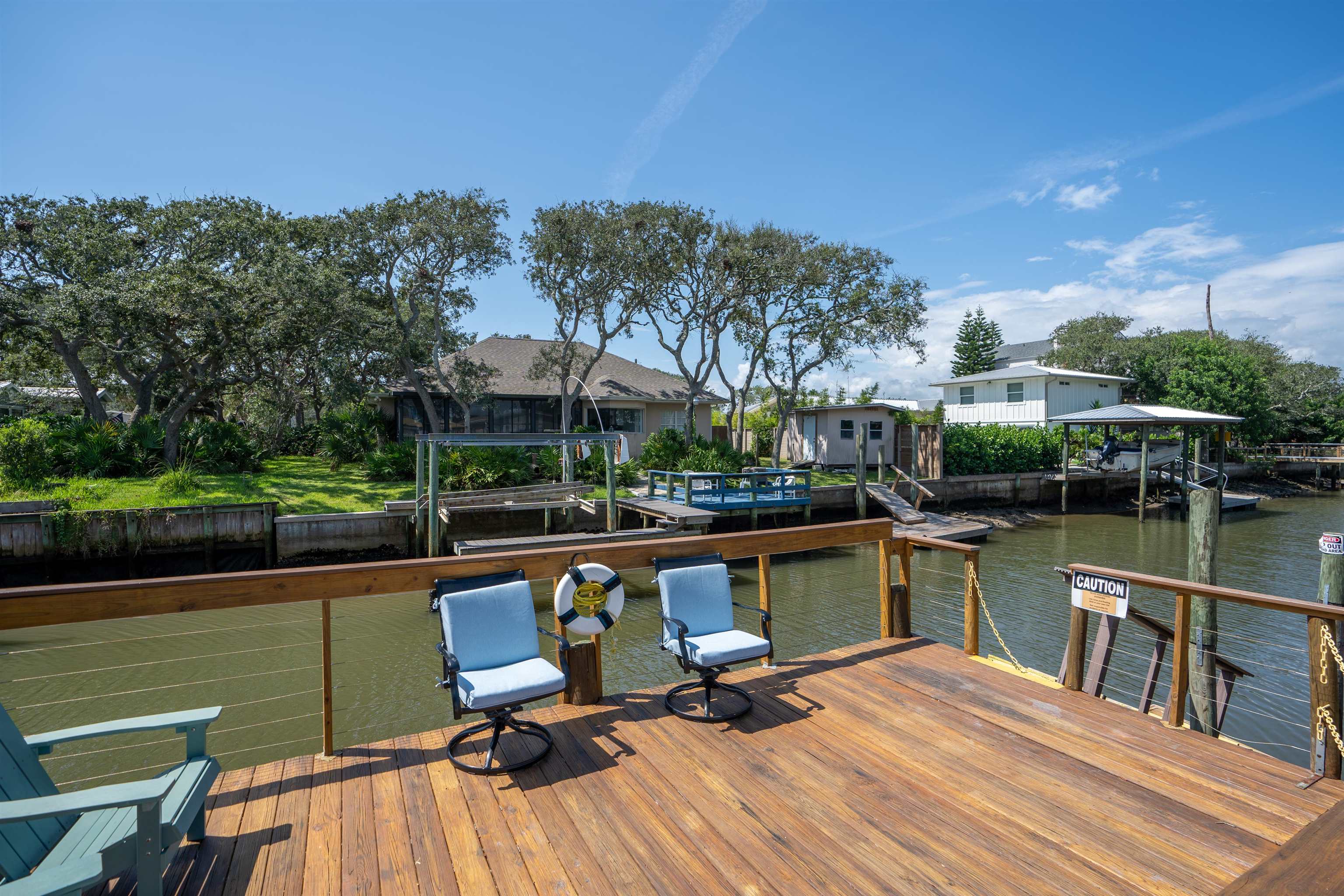 a view of a lake with a table and chairs