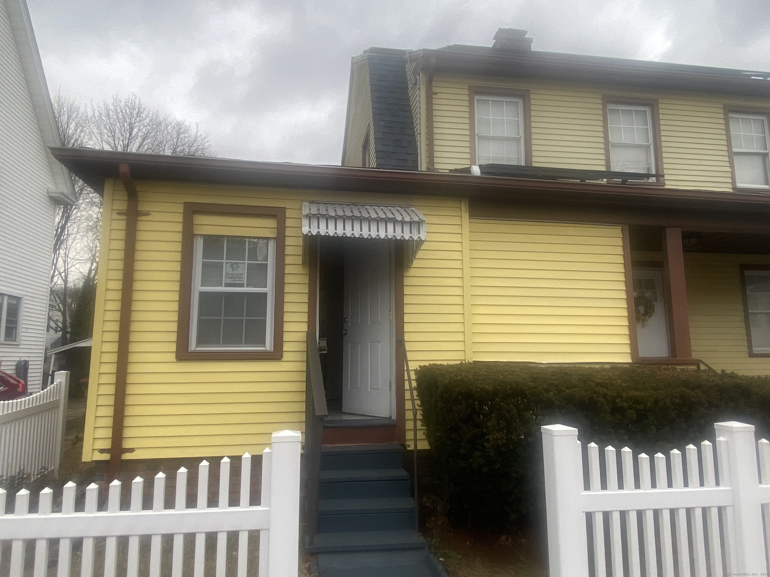 a view of a brick house with a porch