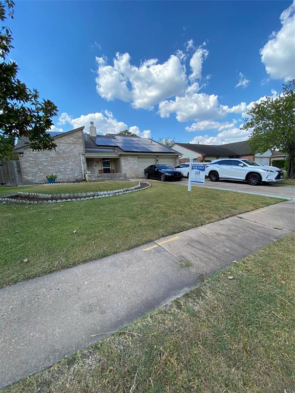 a view of a house with a yard and a garden