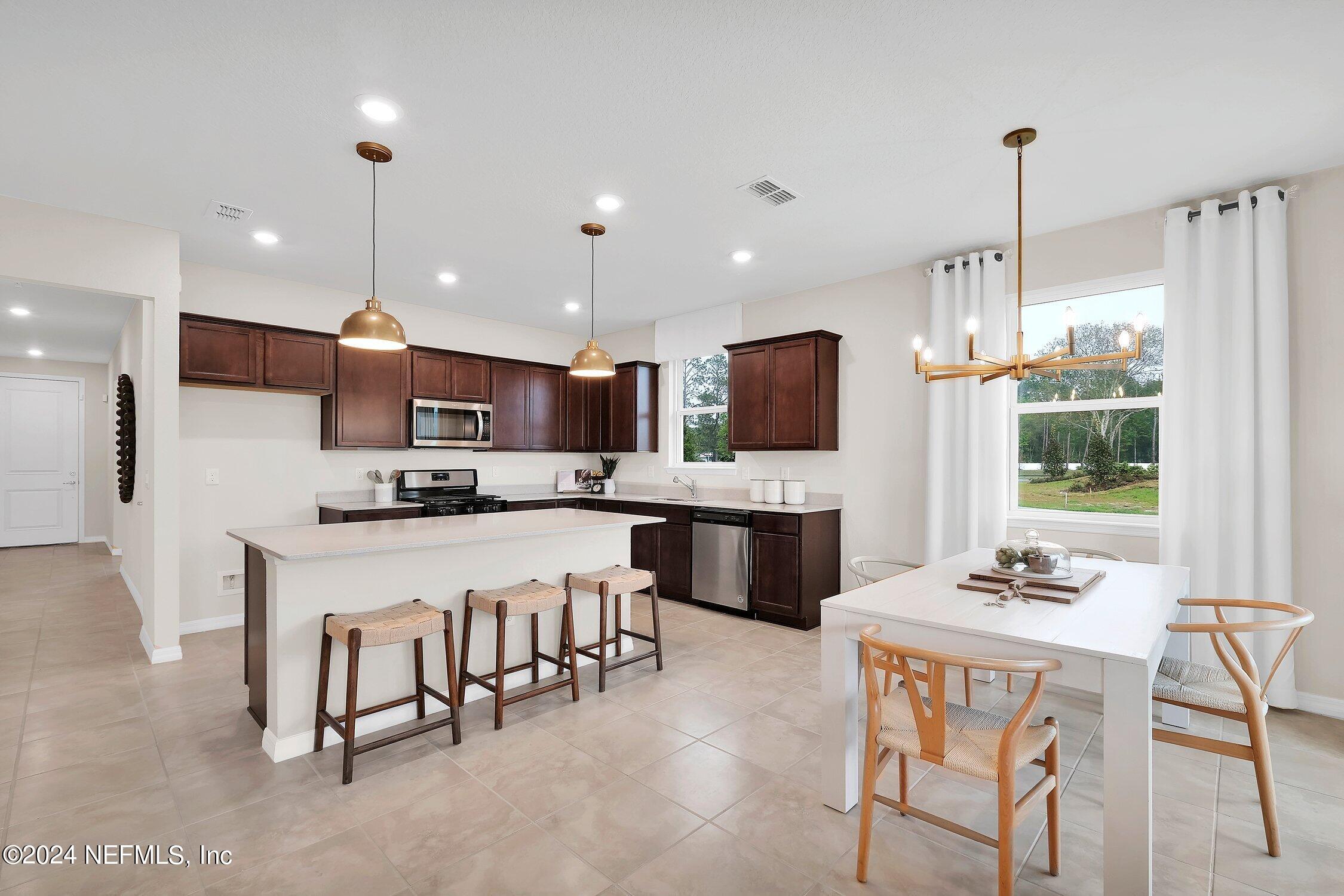 a kitchen with kitchen island granite countertop lots of counter top space and appliances