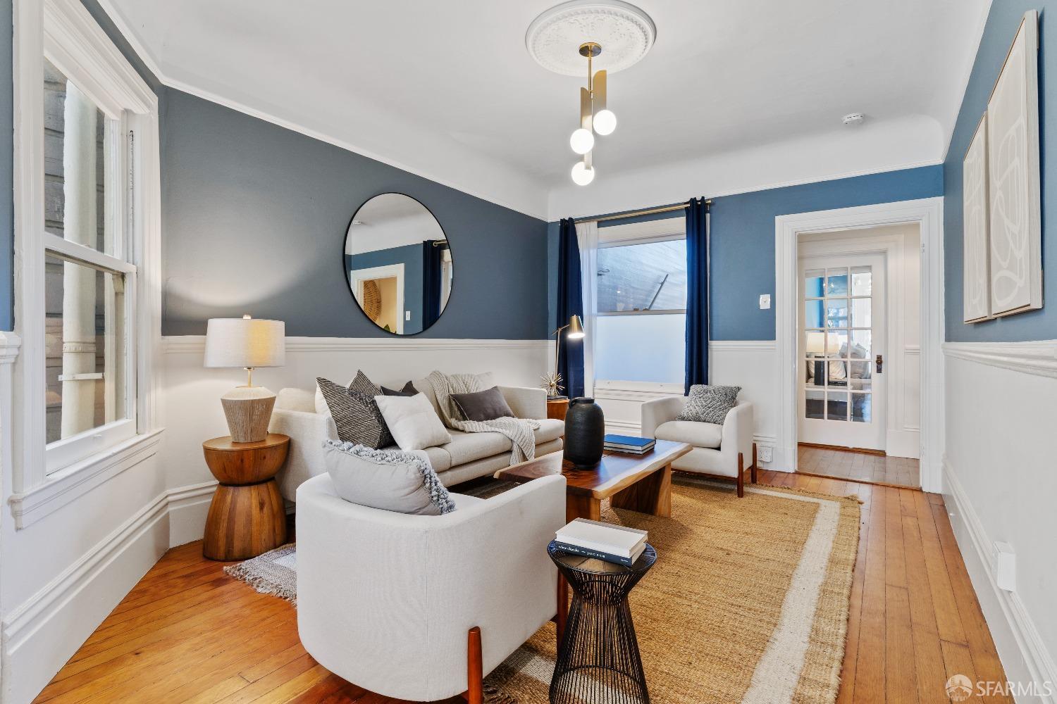 a living room with furniture and a wooden floor