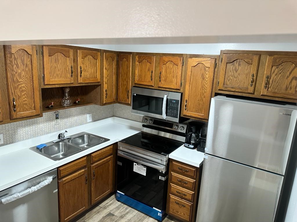 a kitchen with a refrigerator and a sink