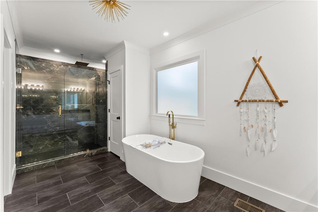 a bathroom with a bathtub and shower