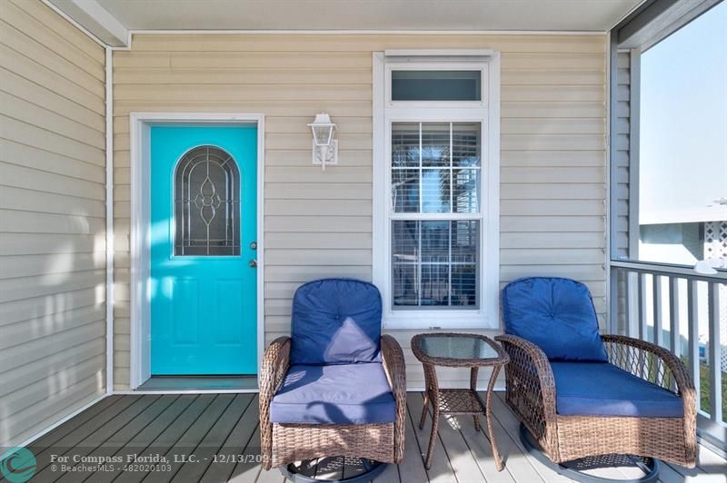 a view of a porch with a chairs and table in a patio