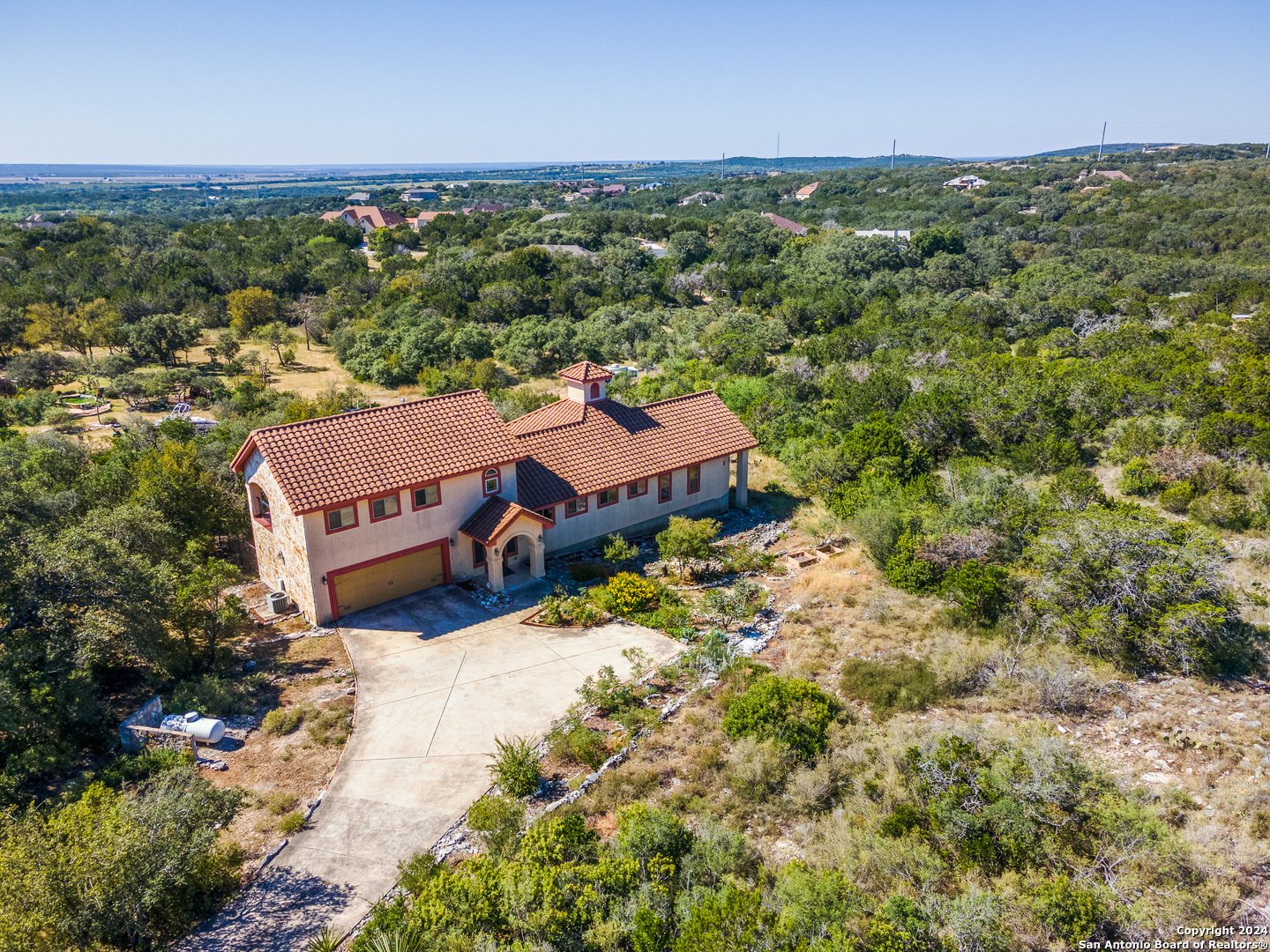 an aerial view of a house with a yard