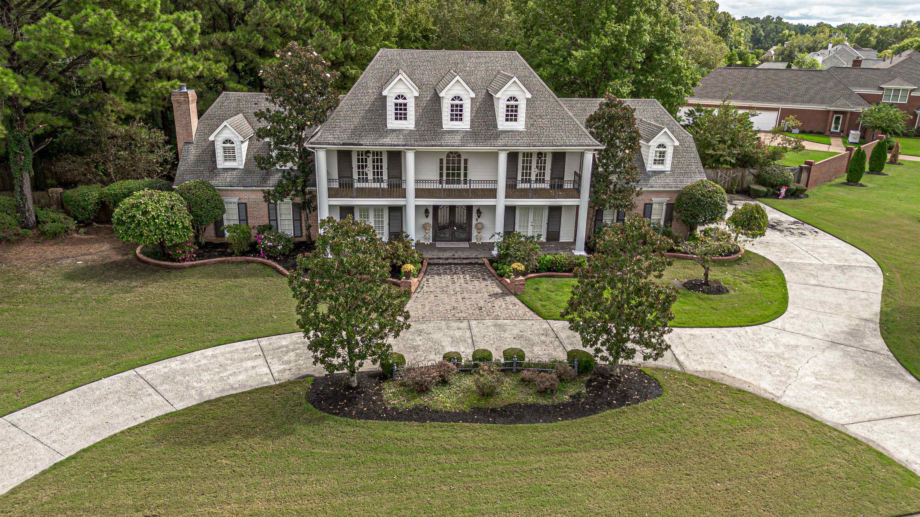 View of front of home with a porch and a front yard