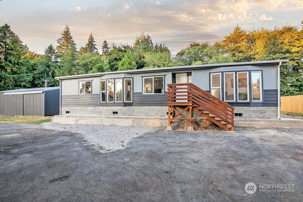 a view of a house with a patio and a yard