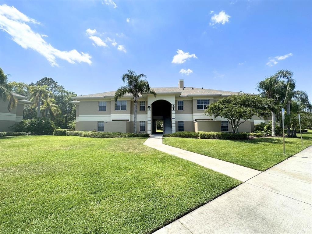 a front view of a house with a yard and a garage