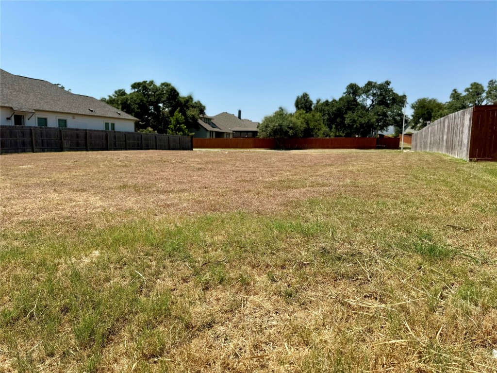 a view of pool with a yard