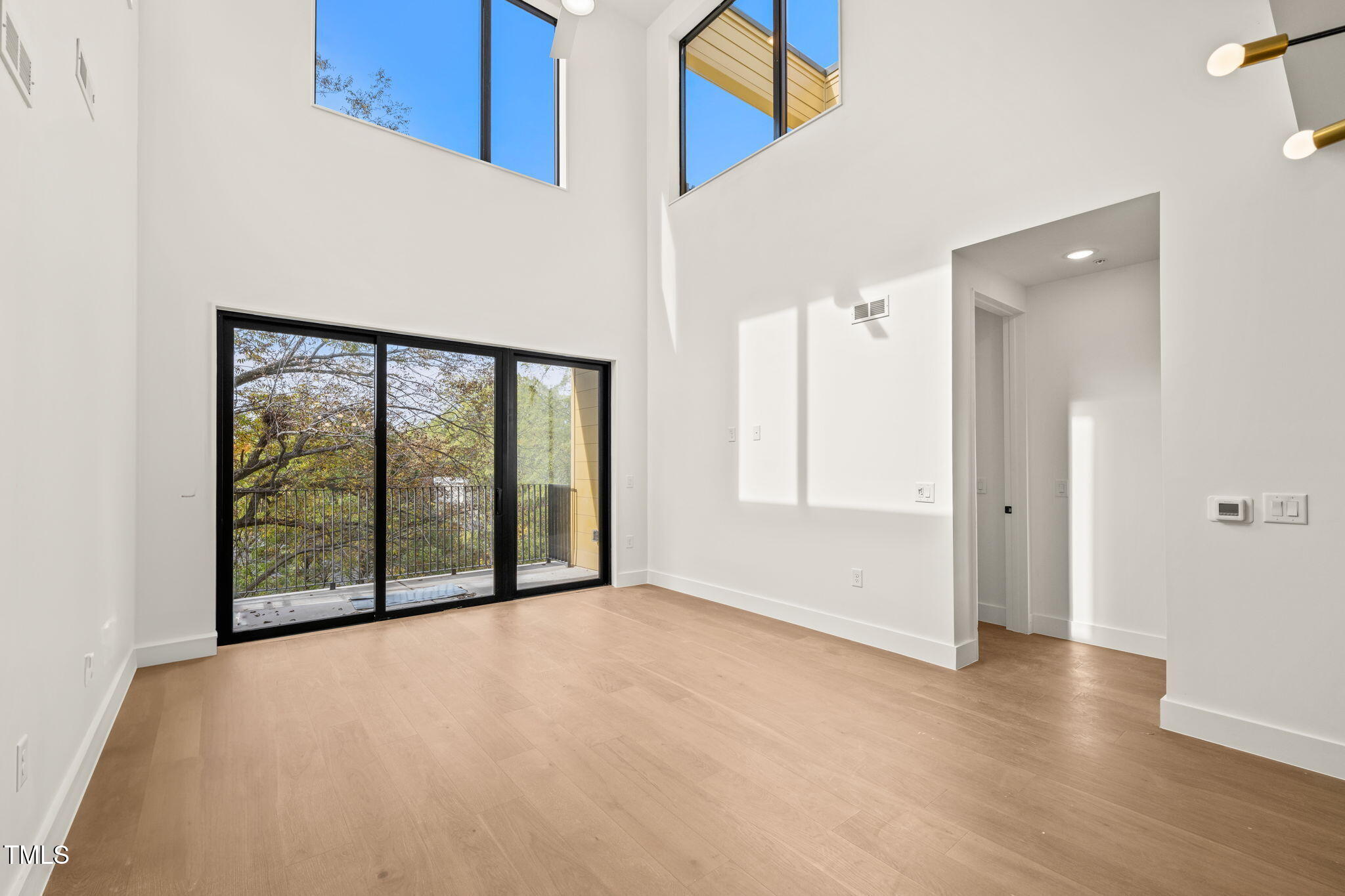 an empty room with large windows