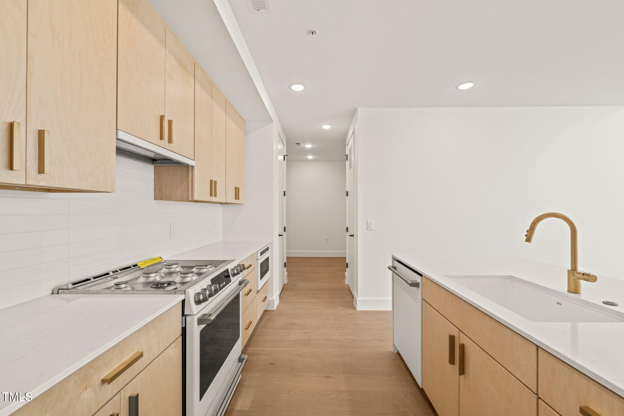 a kitchen with a sink and a stove top oven