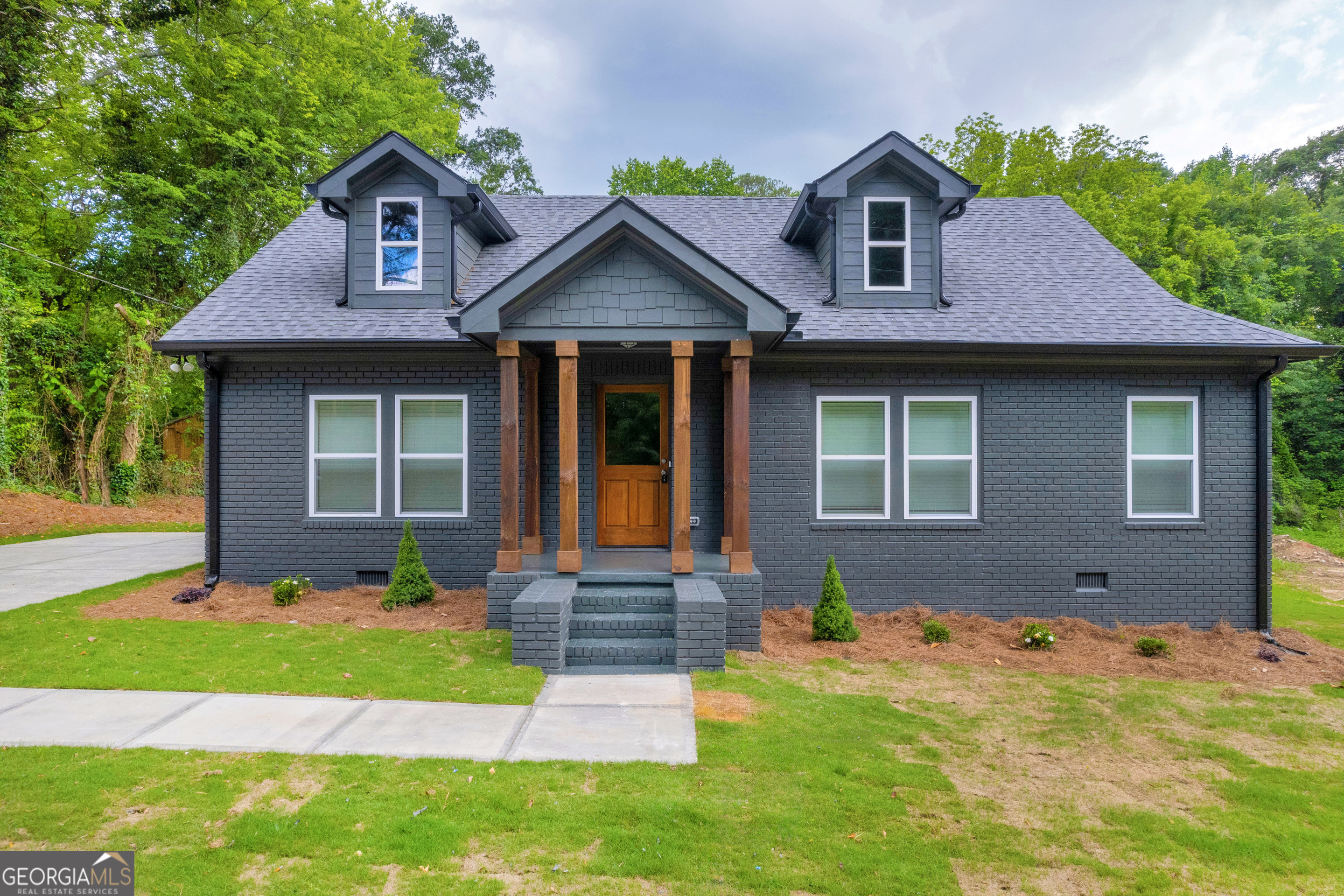 a front view of a house with a yard and garage