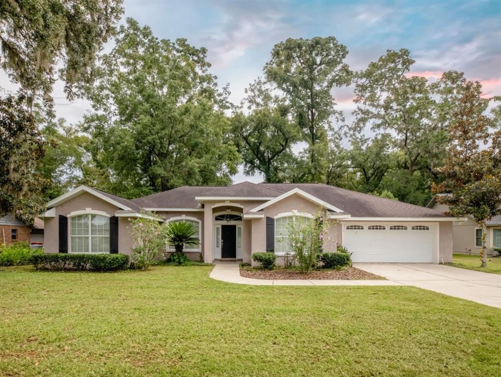 a front view of a house with a yard and garage