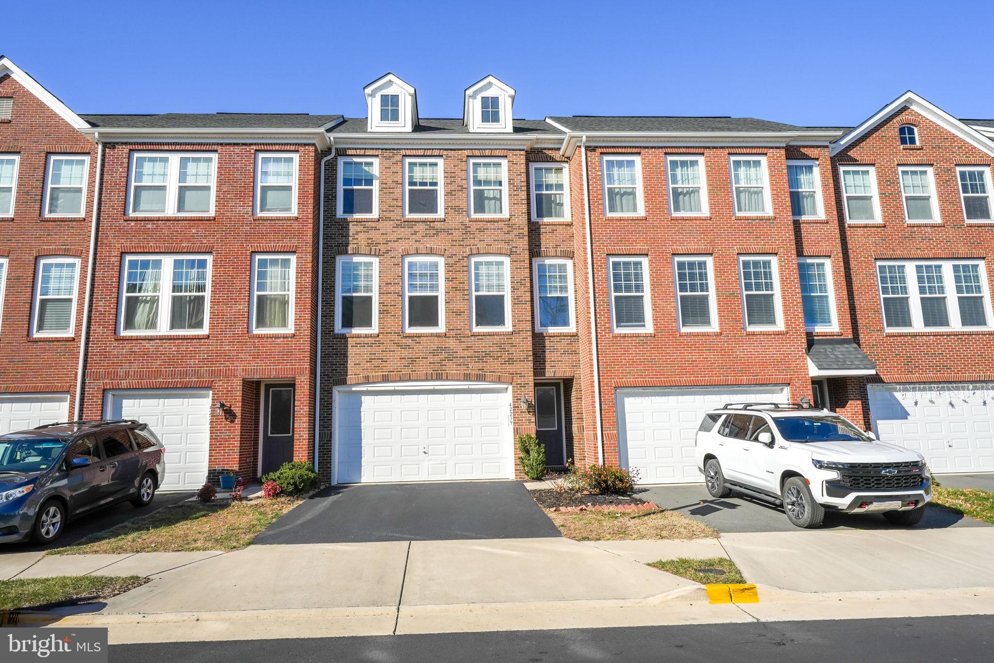 a front view of a residential apartment building with a yard