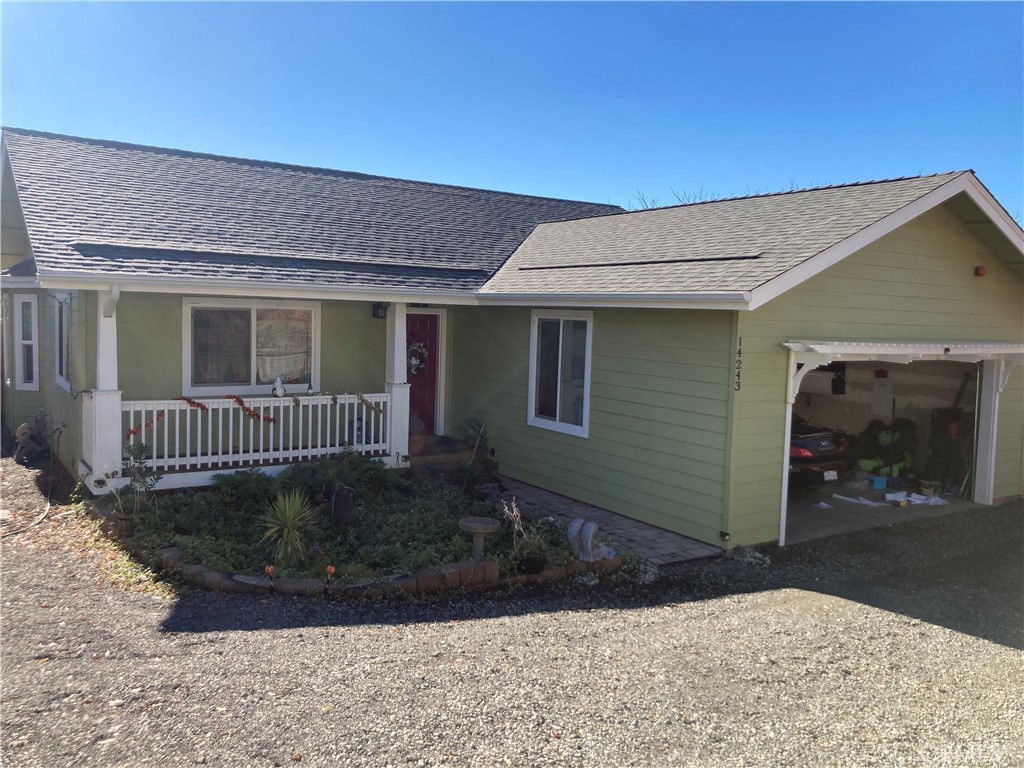 a view of a house with a yard and garage