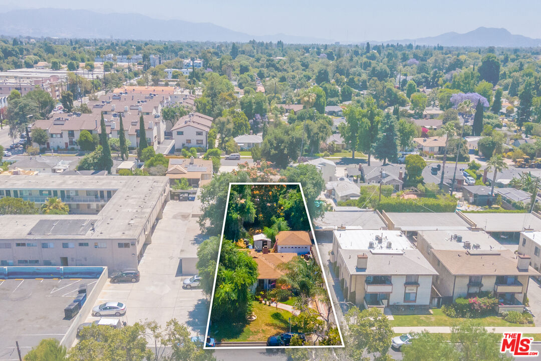 an aerial view of residential houses with yard