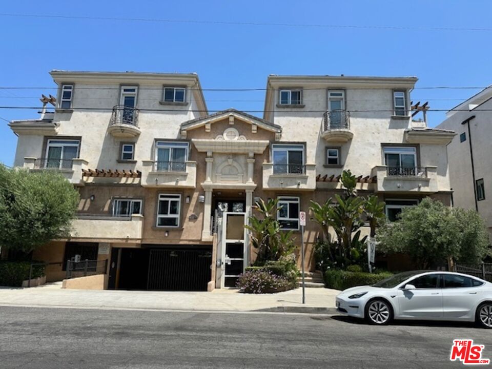 a car parked in front of a white building