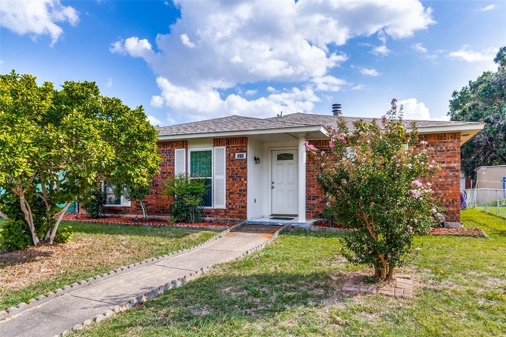 a view of a house with a yard and tree s