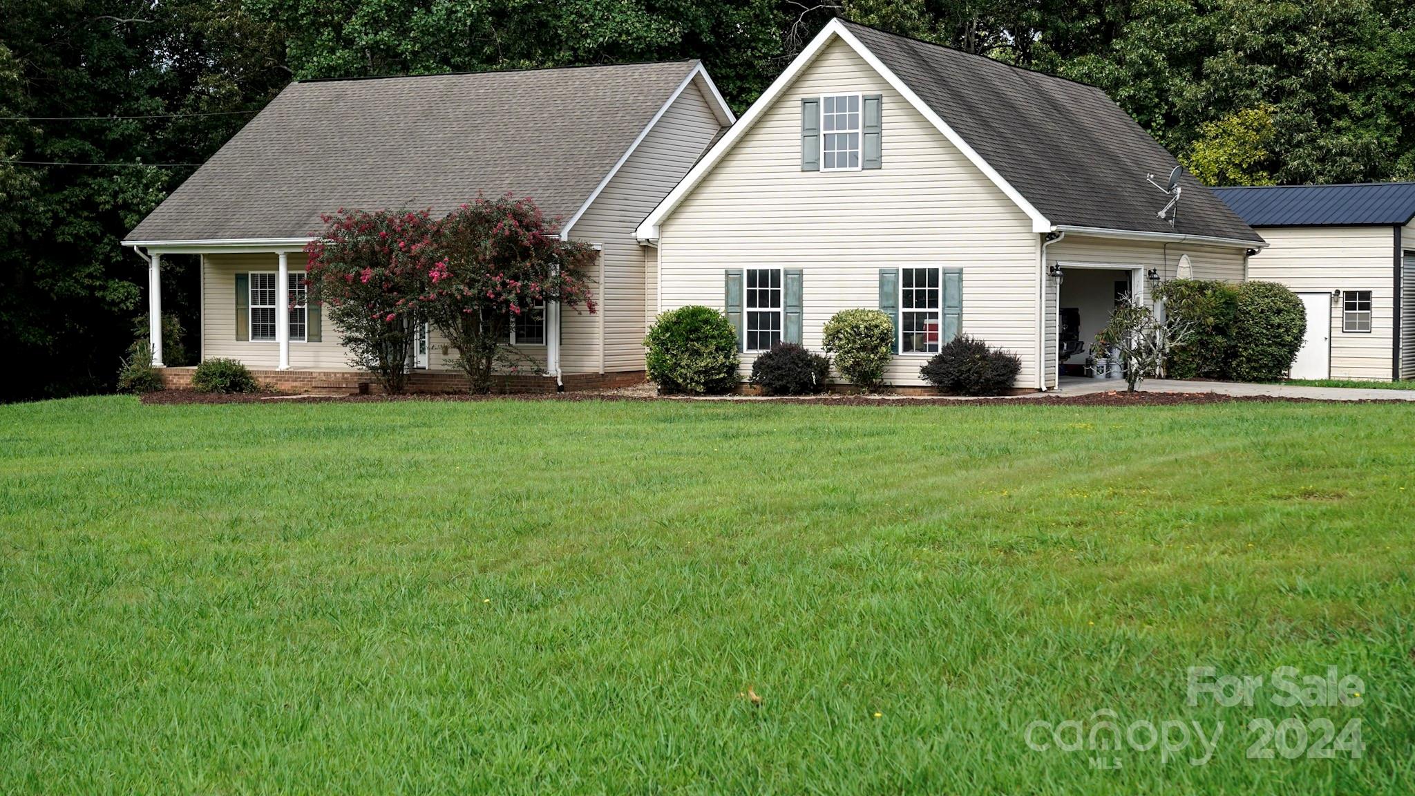 a front view of a house with a garden