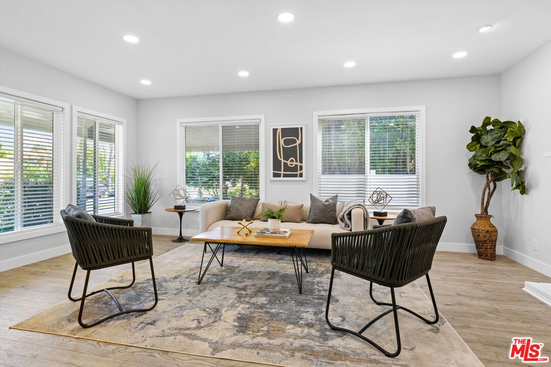 a living room with furniture and a potted plant