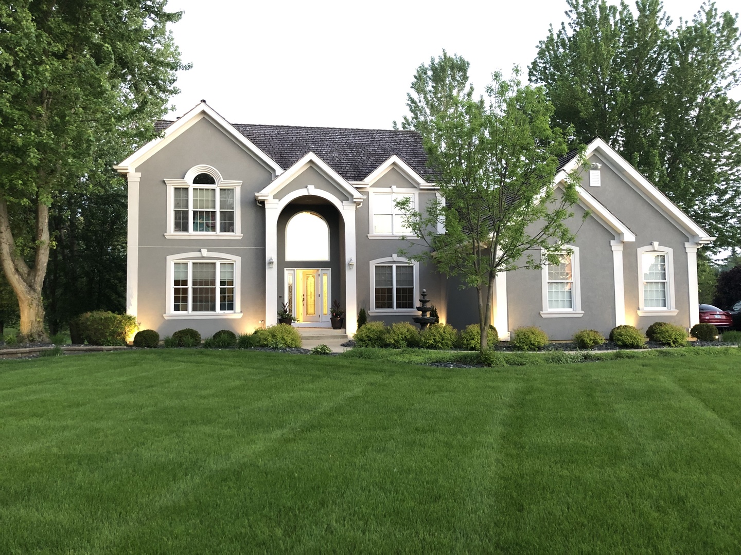 a front view of a house with a garden