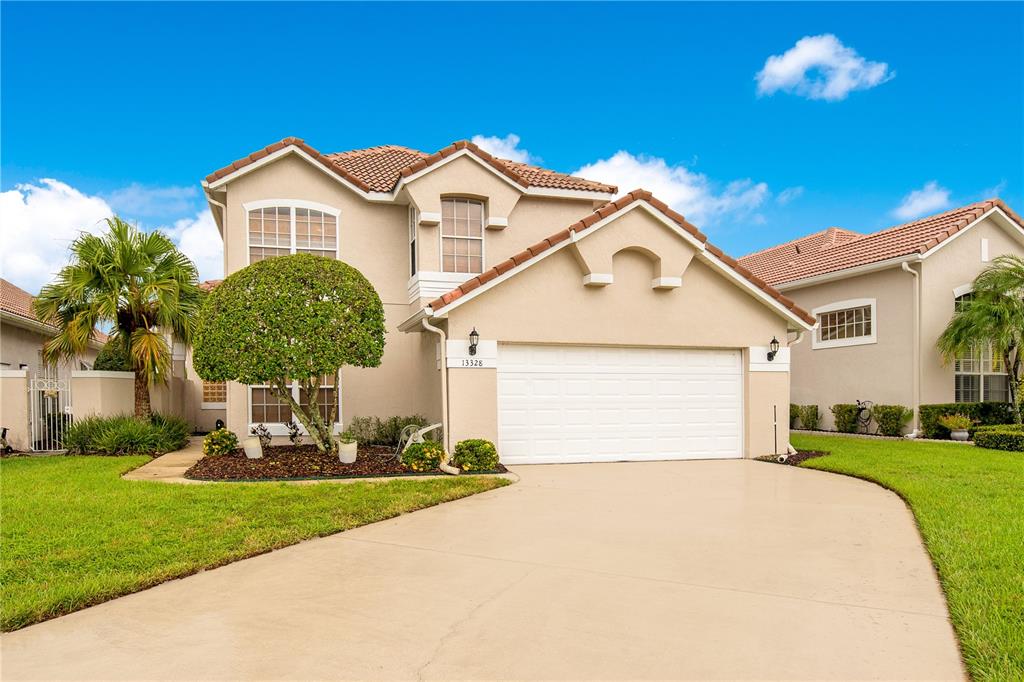 a front view of a house with a yard and garage