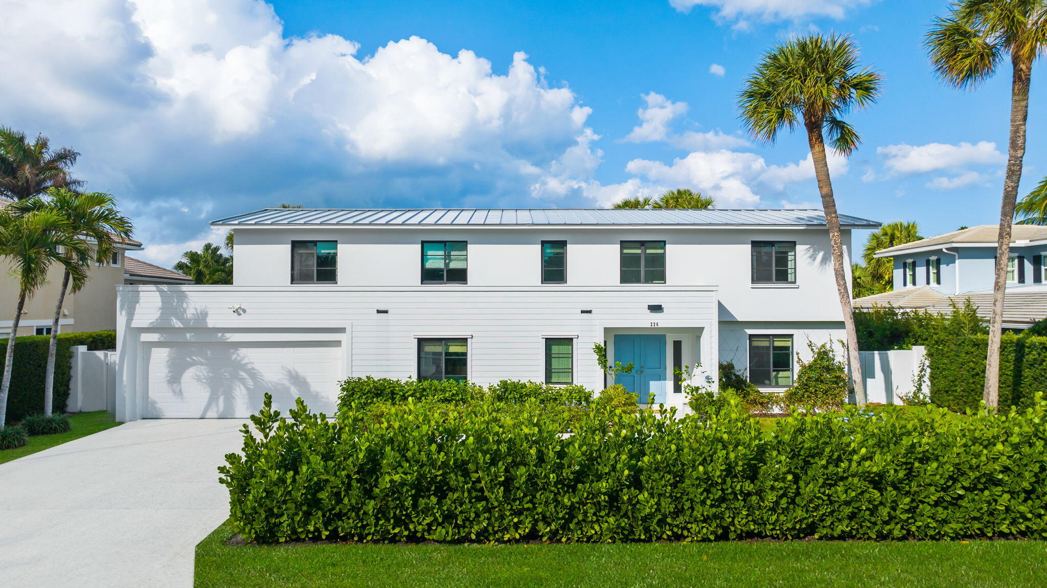 a front view of a house with a garden