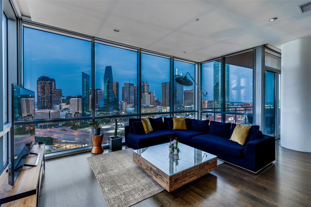 a living room with furniture and large window