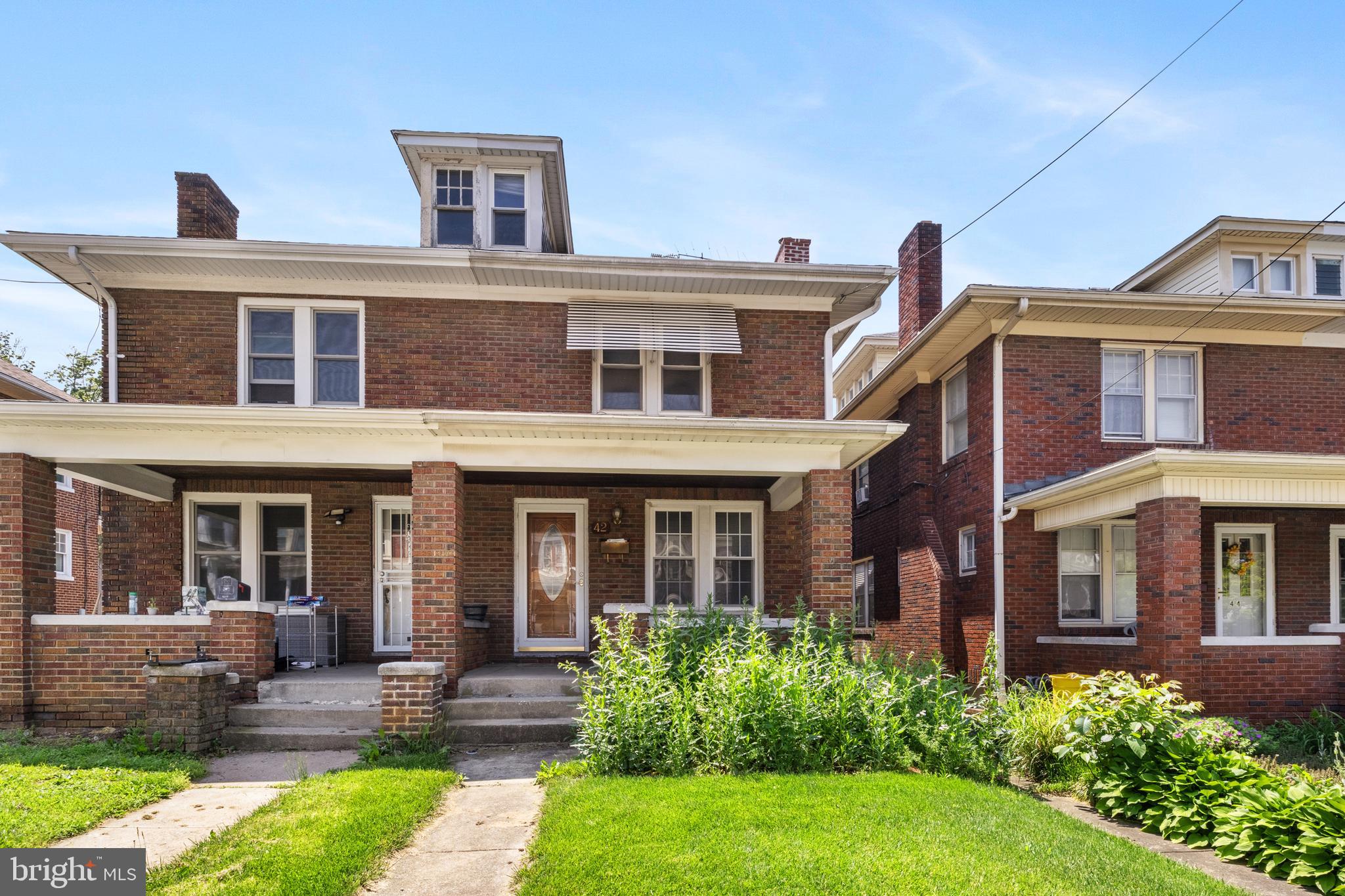 a front view of a house with garden and porch