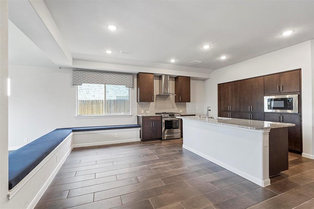 a kitchen with stainless steel appliances a refrigerator and a stove top oven