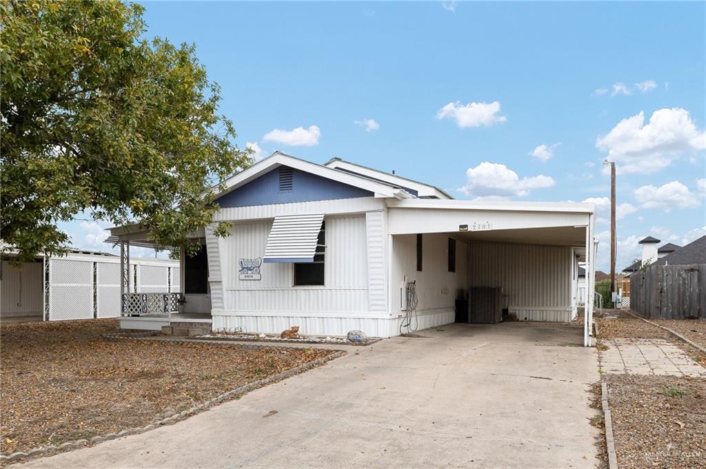 a view of a house with a yard and garage