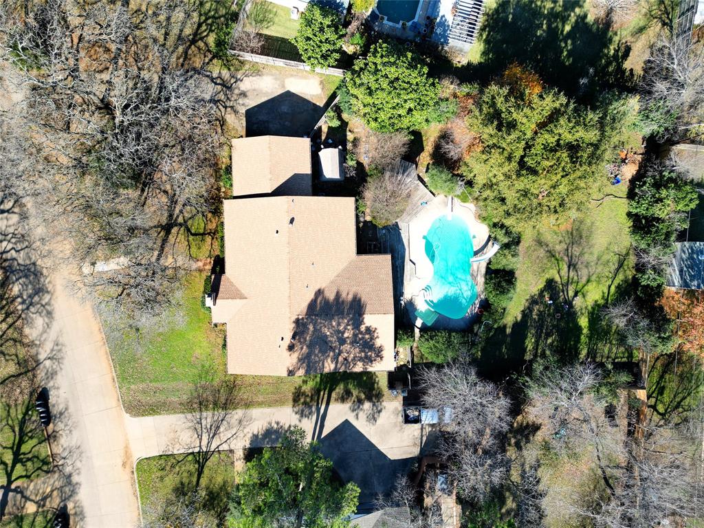 an aerial view of a house with a yard and garden