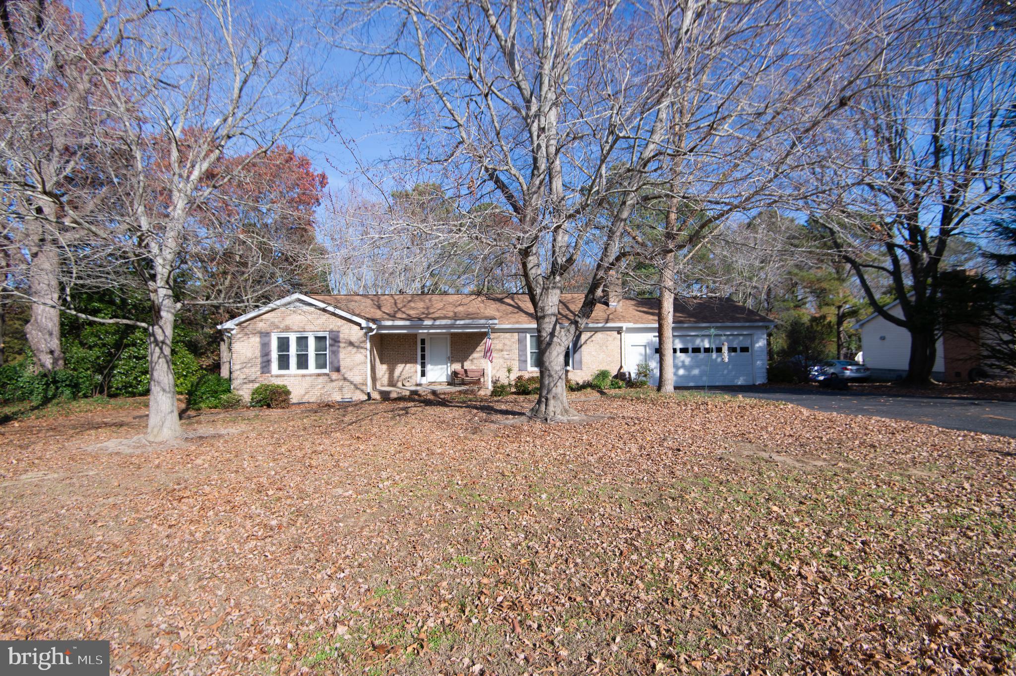 a front view of a house with a yard covered with snow