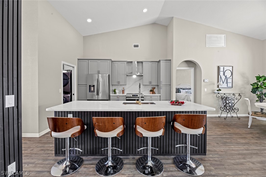 a kitchen with granite countertop a table chairs stove and cabinets