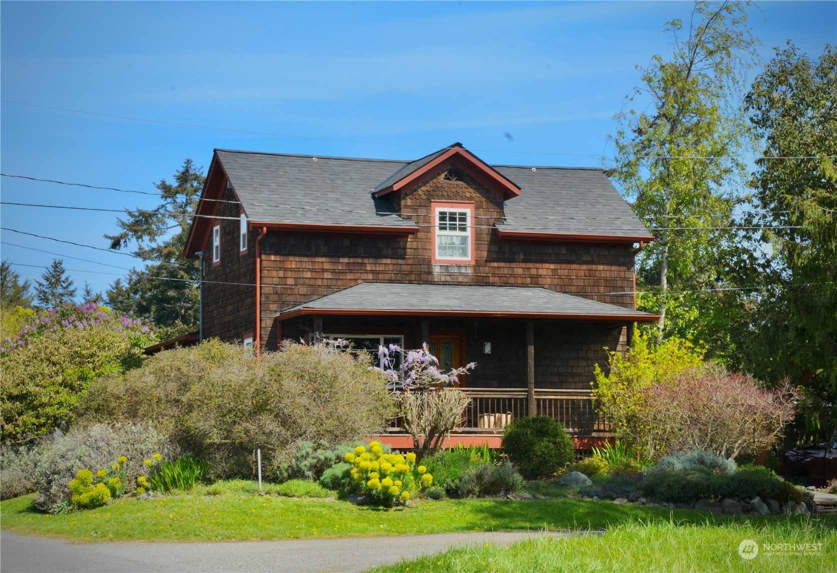 a front view of a house with a garden