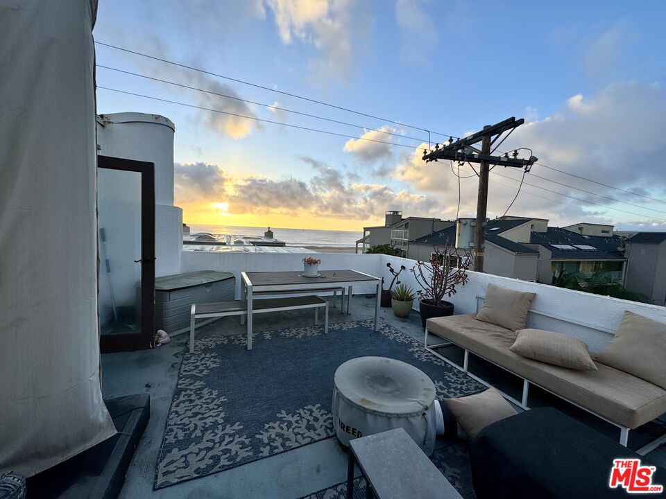 a living room with patio furniture and a flat screen tv