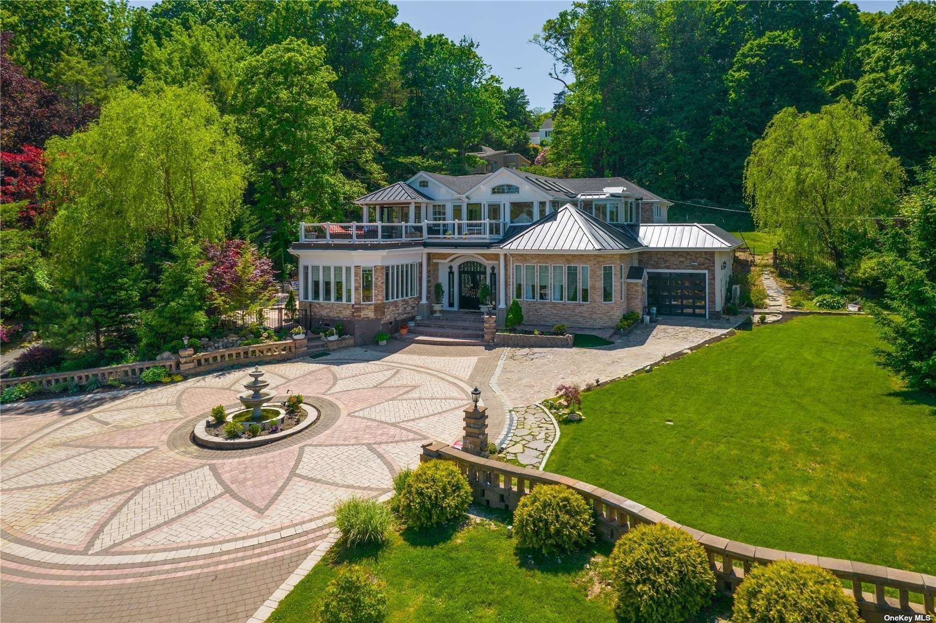 a front view of a house with swimming pool and patio