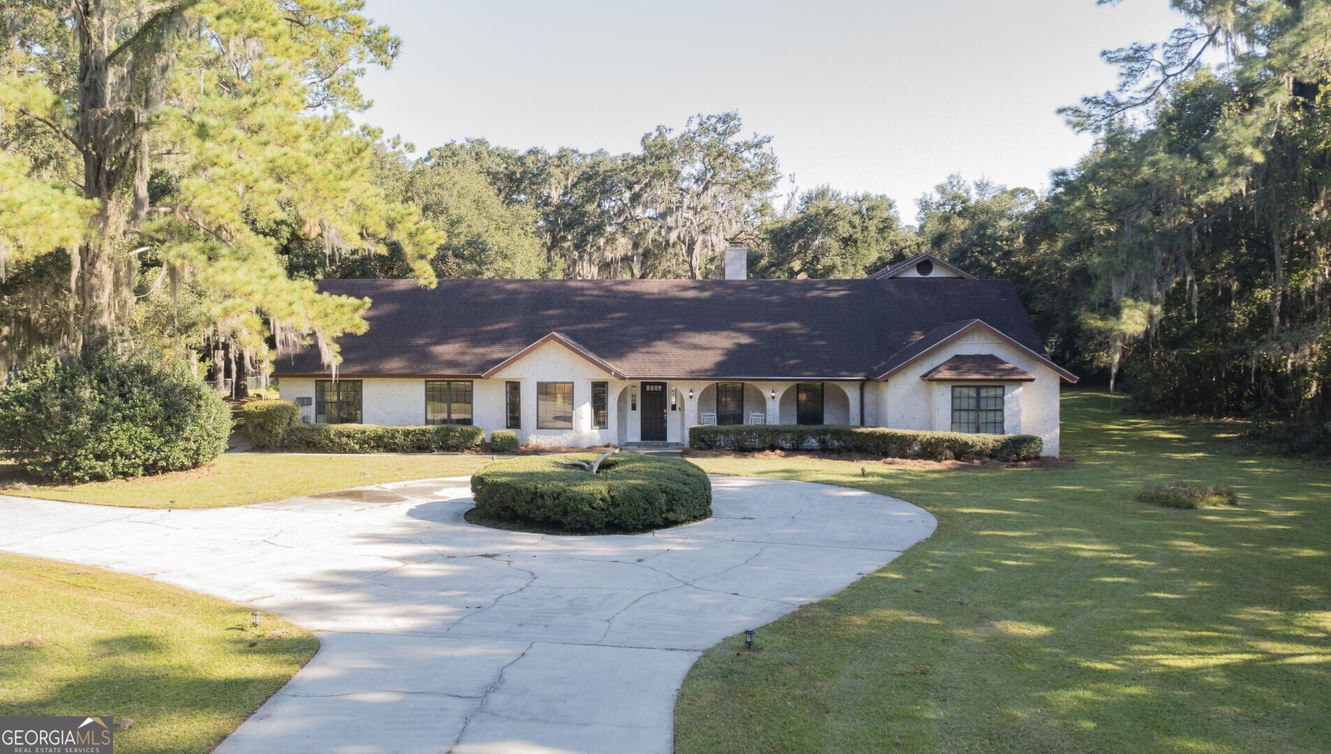 a front view of a house with a garden