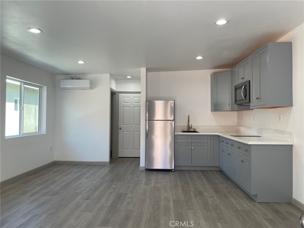 a kitchen with stainless steel appliances granite countertop a refrigerator and a stove top oven