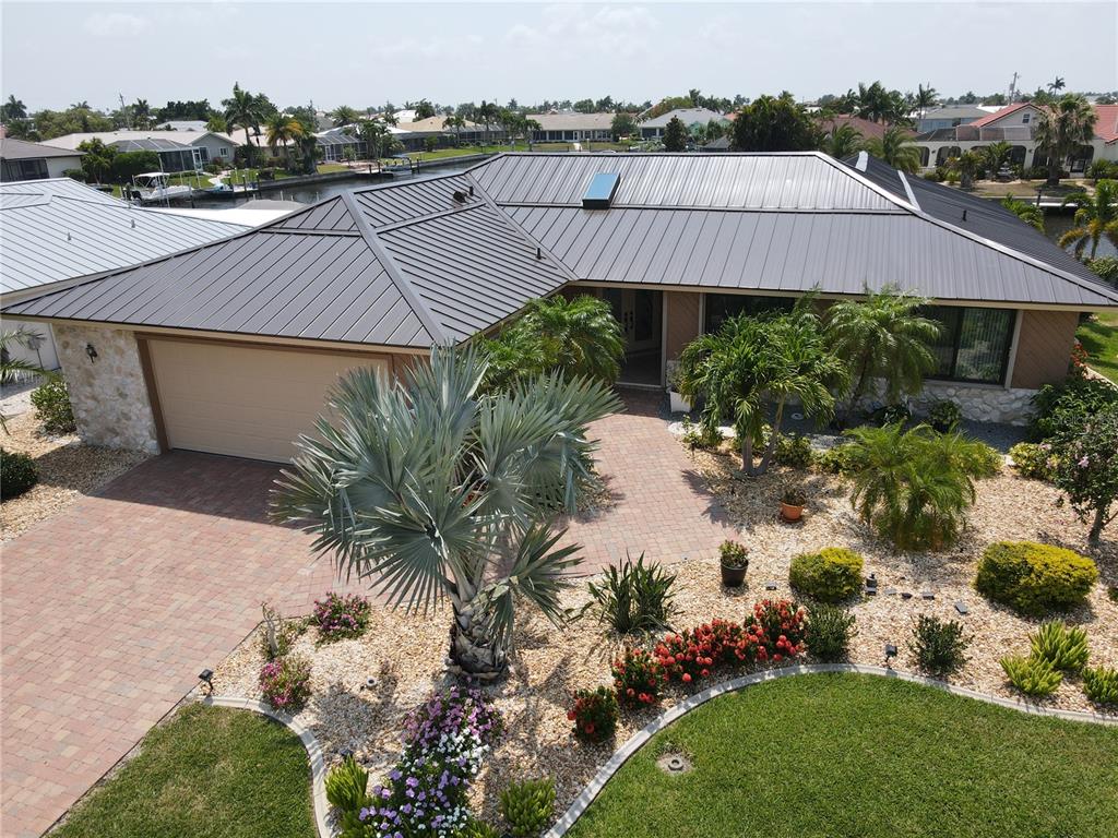 a aerial view of a house with a yard and lake view