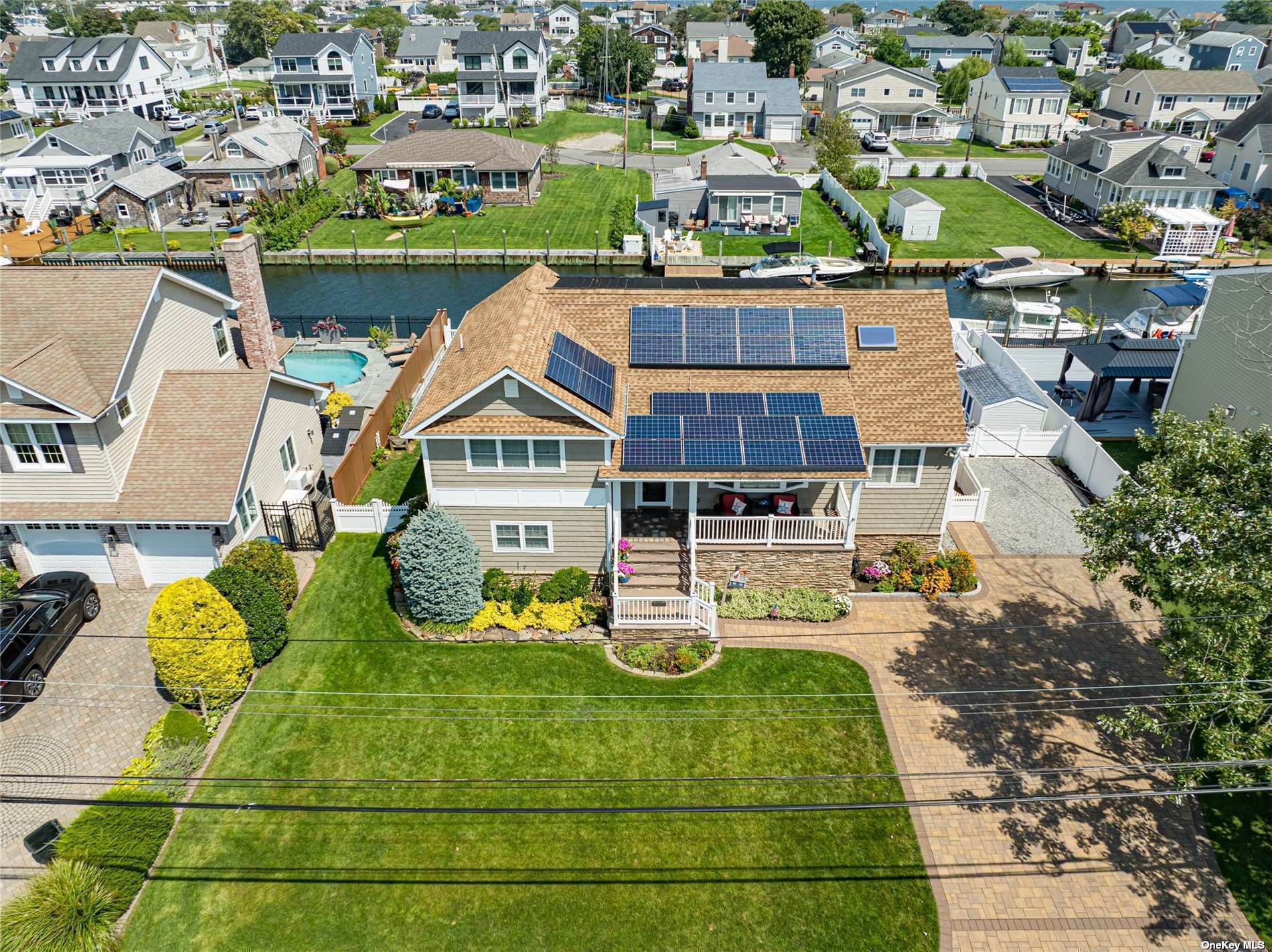 an aerial view of a house with a yard basket ball court and outdoor seating